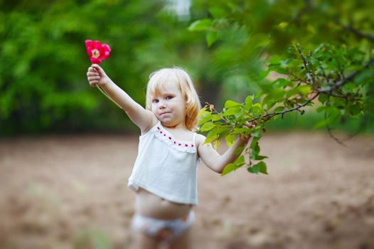 happy small girl with tulip outdoors