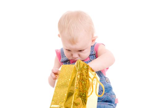 small girl looking presents in the bag