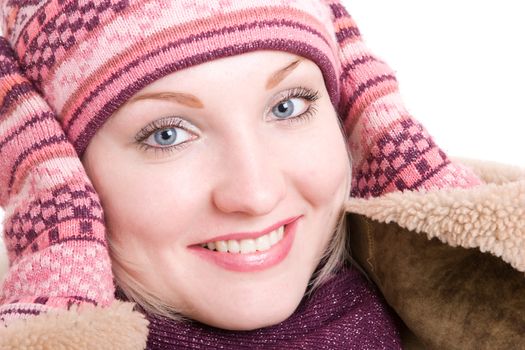 a smiling girl dressed in winter cap, coat, mittens and scarf looks up a smiling girl dressed in winter cap, coat, mittens and scarf looks up