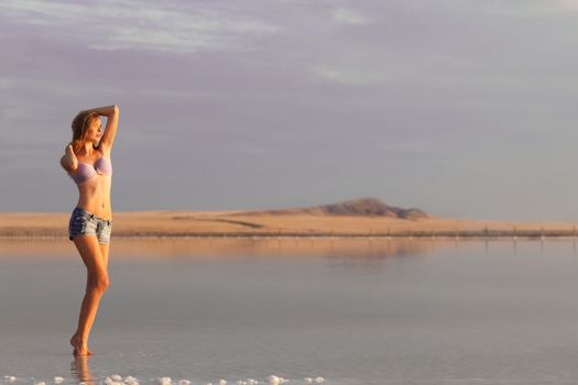 girl in a salt lake in a sunrise