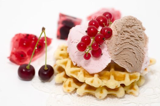 dessert consist of currant, ise-cream, cherry and waffles