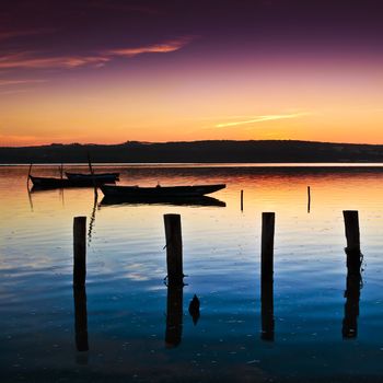 Beautiful landscape of a river and boats at sunset