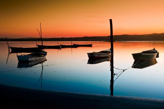 Beautiful landscape of a river and boats at sunset