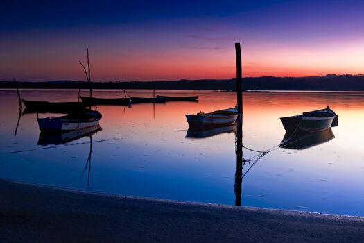 Beautiful landscape of a river and boats at sunset