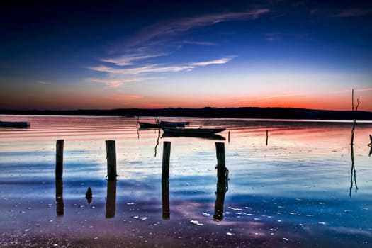 Beautiful landscape of a river and boats at sunset