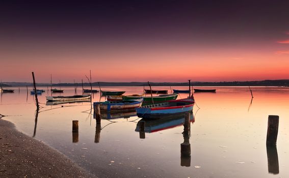 Beautiful landscape of a river and boats at sunset