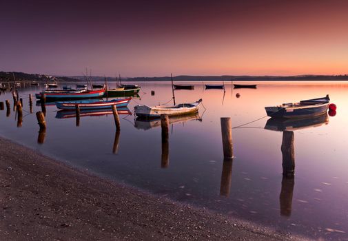 Beautiful landscape of a river and boats at sunset