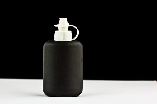 close up of a black cleaning bottle 