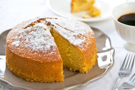 Butter cake with orange zest and juice by coffee