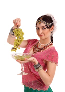 Young girl in the Indian national dress with grapes
