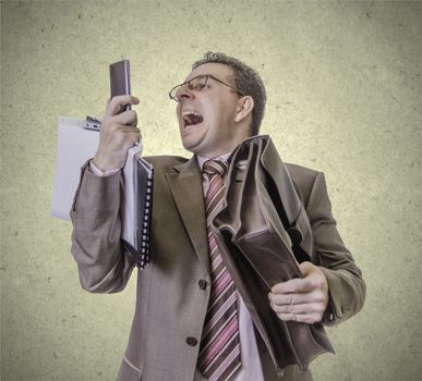 Portrait of busy and angry businessman screaming at smartphone, isolated on white background