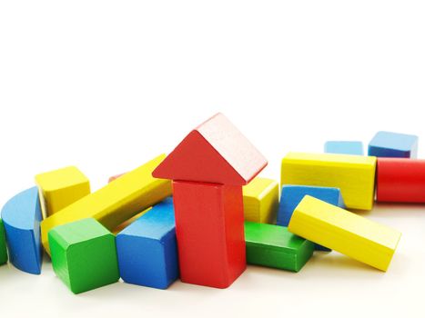 Pile of colorful wooden bricks, assorted colors, isolated towards white