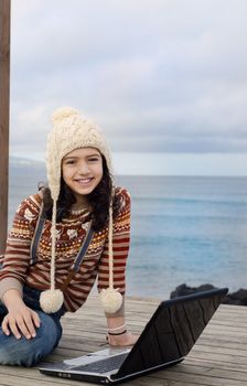 Cute child having a relaxing moment outdoor with the laptop