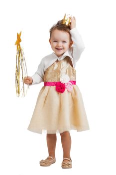 portrait of an happy smiling and laughing little blonde girl with a crown wearing a princess costume and holding a wand isolated on white background