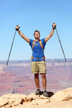 Success winner hiker cheering happy. Man hiking reaching Grand Canyon south rim summit goal. Young fit strong caucasian man.