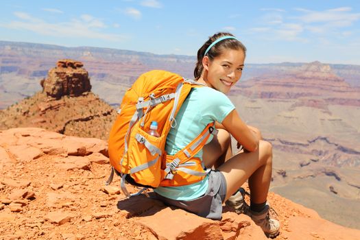 Grand Canyon hiker woman resting portrait. Hiking multiethnic girl relaxing on South Kaibab Trail, south rim of Grand Canyon, Arizona, USA.