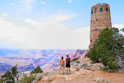 Grand Canyon people hiking. Hiker couple enoying view. Indian Desert View Watchtower, south rim of Grand Canyon, Arizona, USA