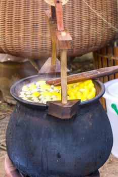 Boiling cocoon in a pot to prepare a cocoon silk.