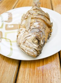 Fried fish on white dish, delicious thai food