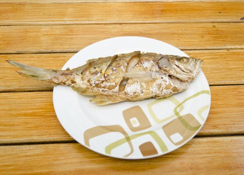 Fried fish on  wood background, delicious thai food