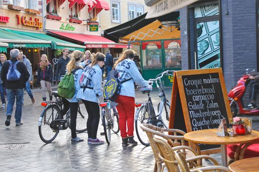 Three girls with bicycles in Valkenburg. Netherlands