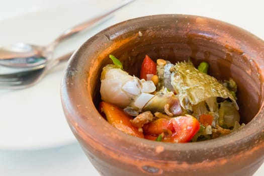 thai food papaya salad with horse crab in mortar on white table