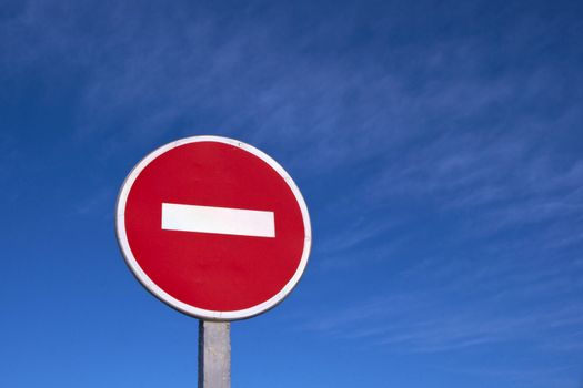 Road stop sign against clear deep blue sky