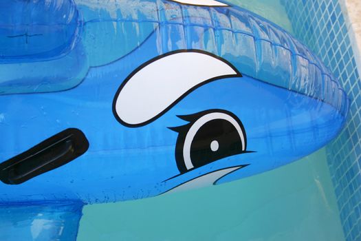 Close up of an inflatable lilo dolphin in a swimming pool. Horizontal picture