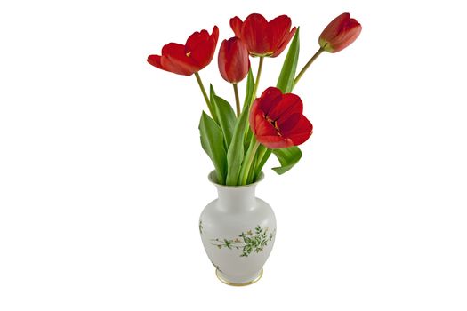 Red tulips in a china vase isolated on white