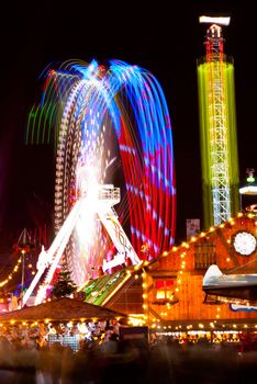 long exposure pictures of amusement park rides and wheels at night