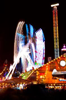 long exposure pictures of amusement park rides and wheels at night