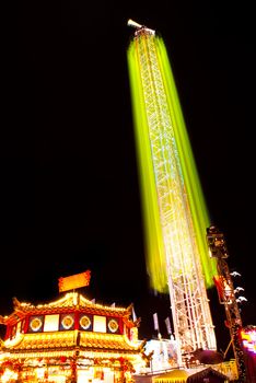 long exposure pictures of amusement park rides and wheels at night