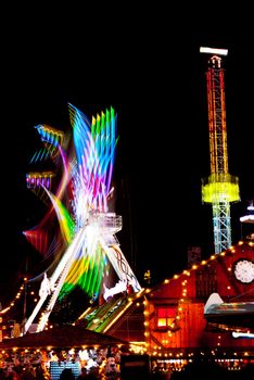 long exposure pictures of amusement park rides and wheels at night