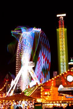 long exposure pictures of amusement park rides and wheels at night