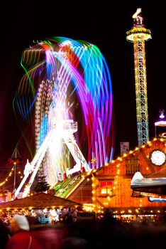 long exposure pictures of amusement park rides and wheels at night