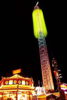 long exposure pictures of amusement park rides and wheels at night