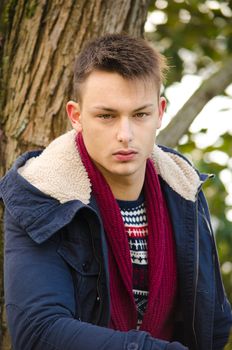 Portrait of handsome young man with winter clothes outdoors
