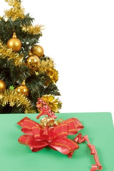 yellow decorated christmas tree  and gift with red ribbon on white background