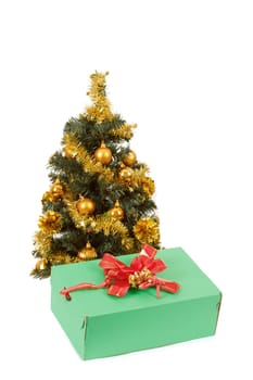 yellow decorated christmas tree  and gift with red ribbon on white background