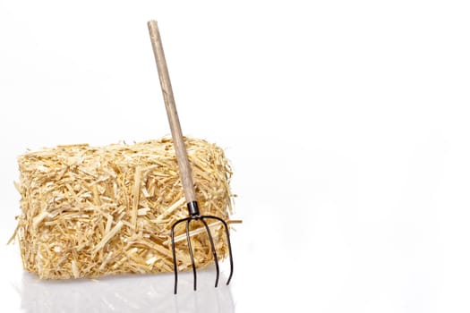 Haybale with tool on a white background