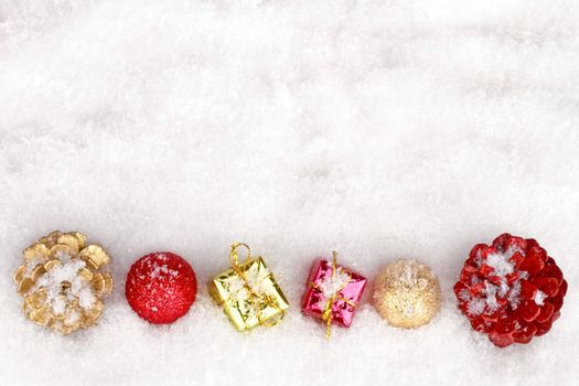 Christmas ornaments and presents on a snowy background