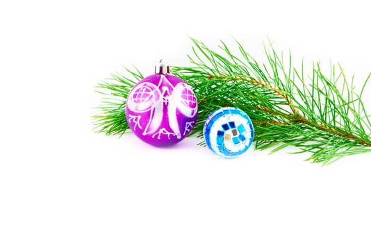 Bright colored Christmas toys on green fir branches