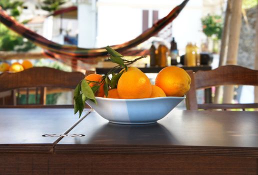 Summer terrace with hammock and oranges on the table 