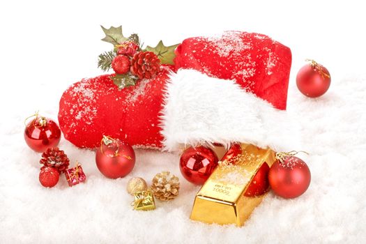 The red boot from Santa Claus in the snow, filled with christmas presents, ornaments and a gold