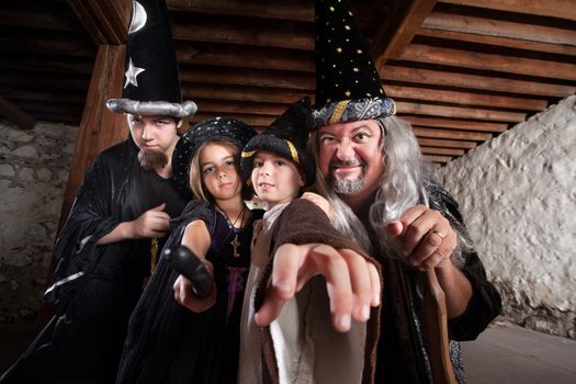 Father and children in mythical wizard costumes