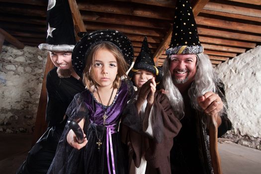 Magician father and children casting spells in a basement