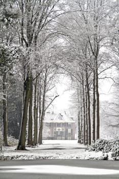 Medieval mansion in the woods in winter in the Netherlands
