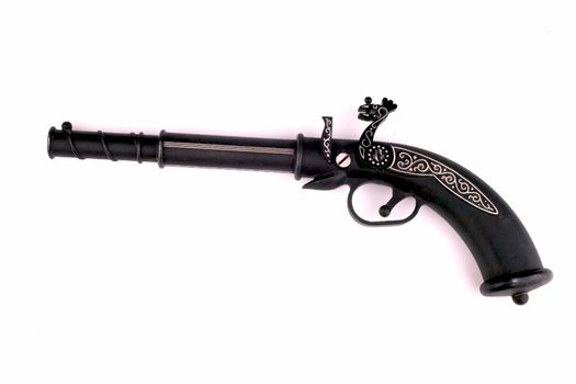 General view of an old pistol in black on a white background