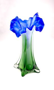 Glass vase green-blue color in the form of a flower on a white background