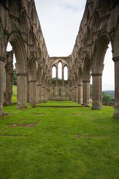 Scenic view of ruins of Rievaulx Abbey under cloudscape, North Yorkshire Moors, National Park, England